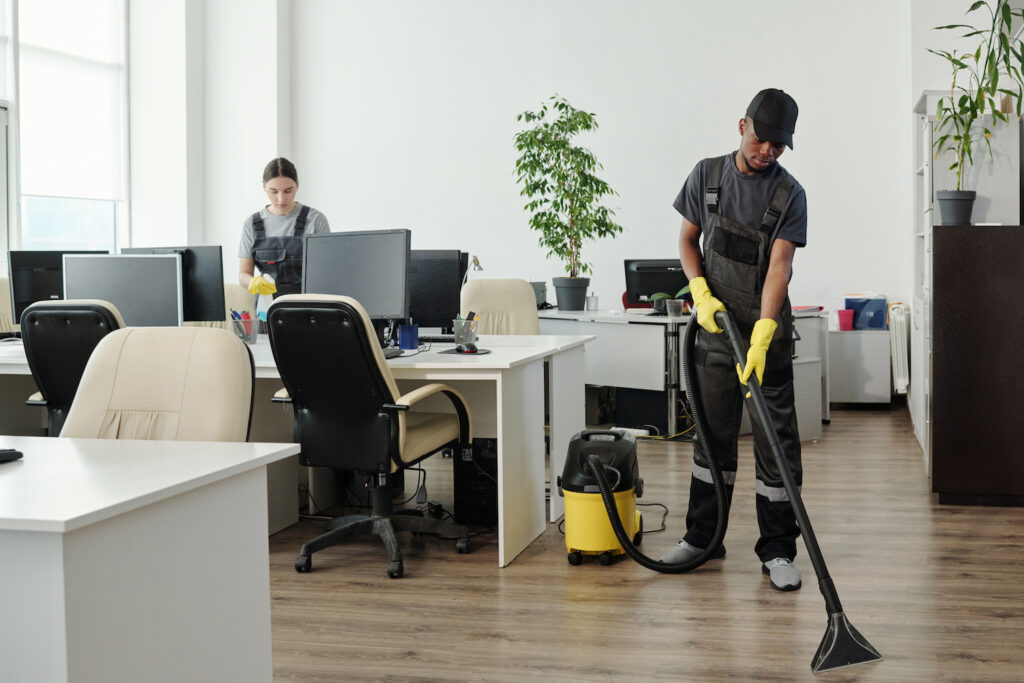 Two cleaners working in a modern office space.