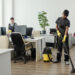 Two cleaners working in a modern office space.
